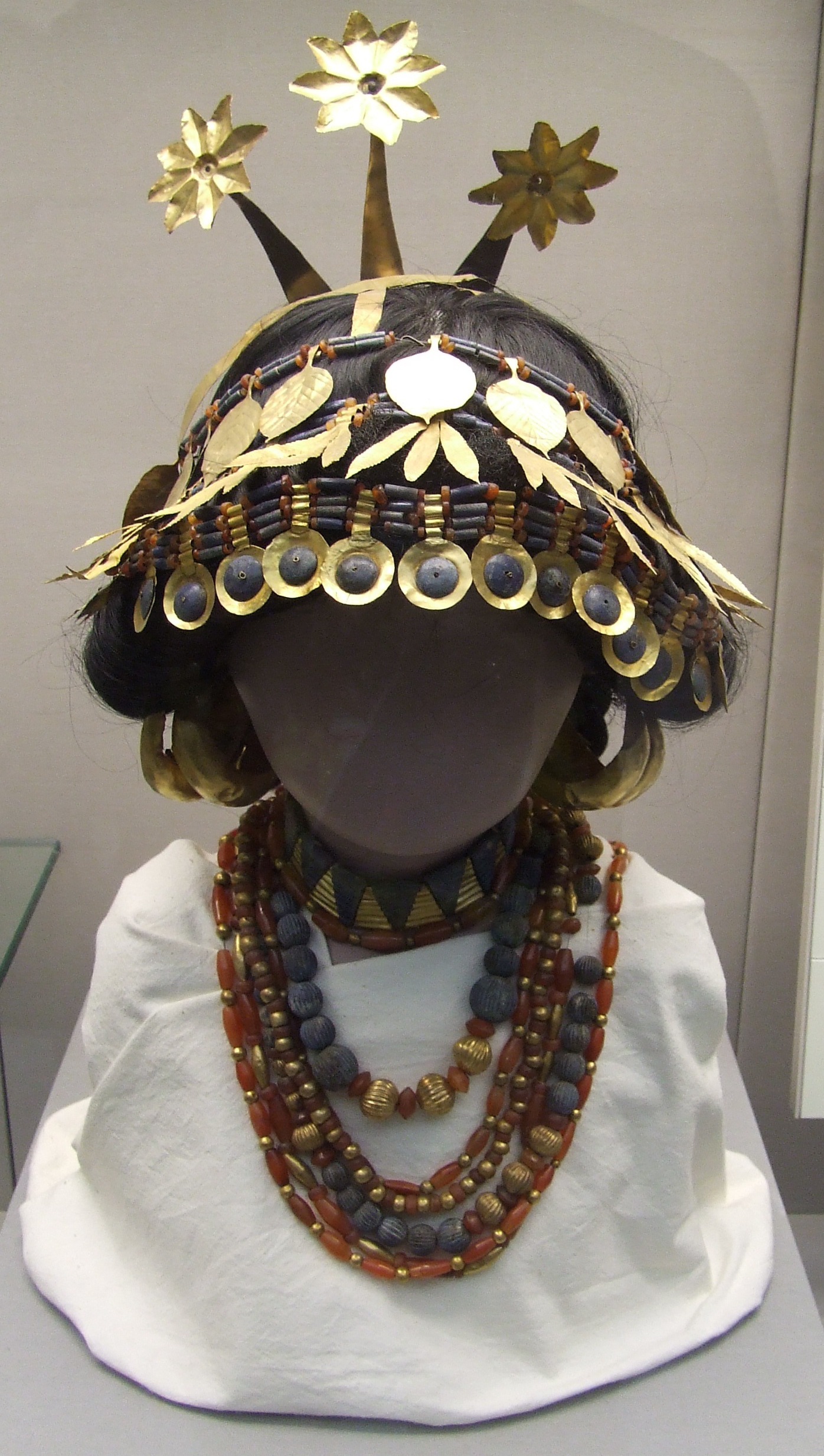 Gold royal headdress with beaded precious stone jewelry of ancient Sumeria. Foliage and seed patterns. International.